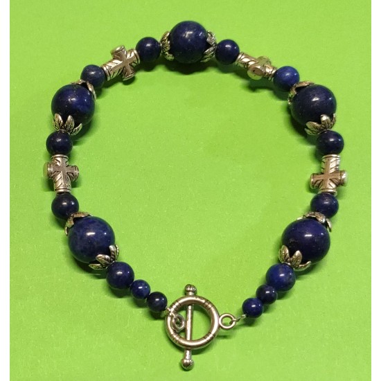Bracelet about 21 cm. Lapis lazuli beads, Tibetan silver caps and cross spacers. The bracelet is handmade on silicone wire with silver toggle clasps.