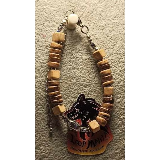 Bracelet made of coconut beads, wood and Tibetan silver Buddha metal beads, on silicone wire with stainless steel lobster clasps with 7 cm extension. It is made by hand on silicone wire.