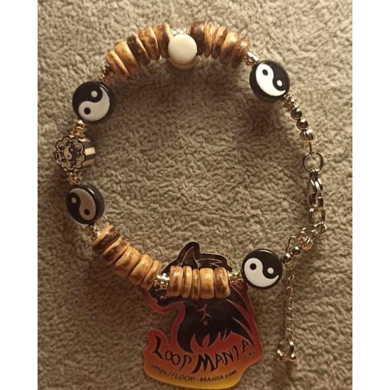 Bracelet made of coconut beads, wood and metal beads on silicone wire with stainless steel lobster clasps with 5 cm extension. 