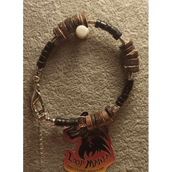 Bracelet made of coconut beads, wood and metal beads on silicone wire with stainless steel lobster clasps with 5 cm extension. 