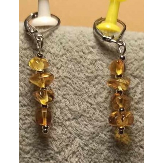 Earrings made of amber beads and stainless steel balls. 