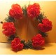 Fir wreath with artificial flowers, carnations.