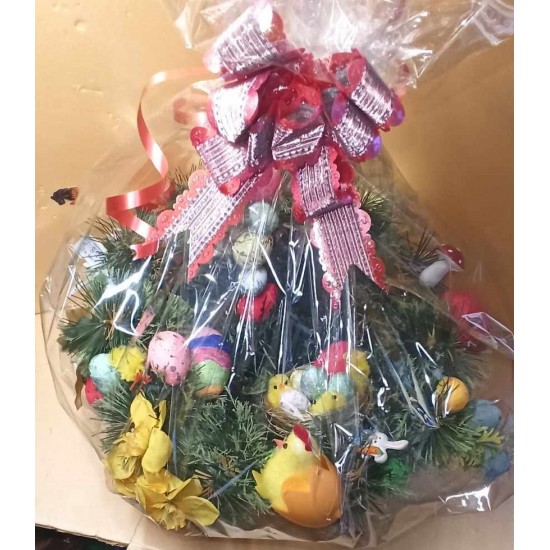 Easter decoration. Basket for Easter-dyed eggs made of fir and artificial flowers with polystyrene eggs, rabbit and poppies.